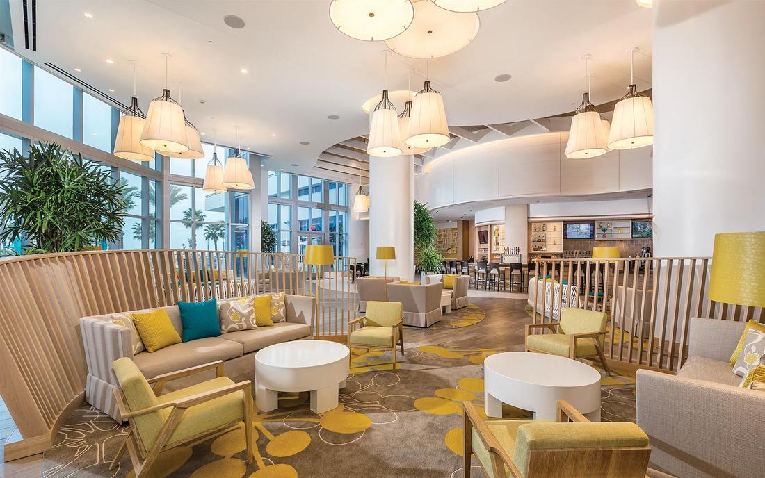 The open lobby lounge with seating and floor-to-ceiling windows